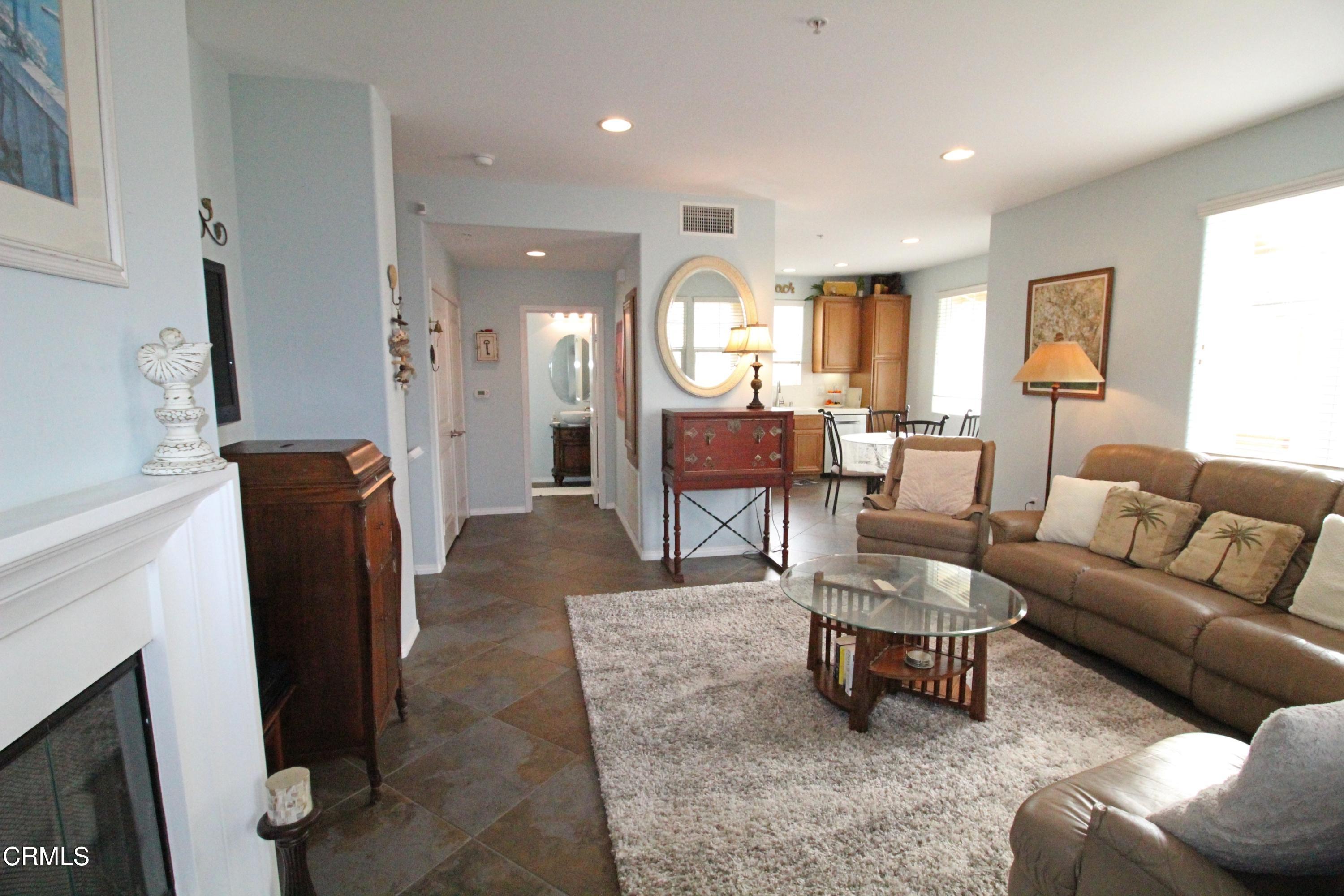 1428 Windshore Way Oxnard, CA 93035 - Photo 3 of 29 a living room with furniture a fireplace and a window