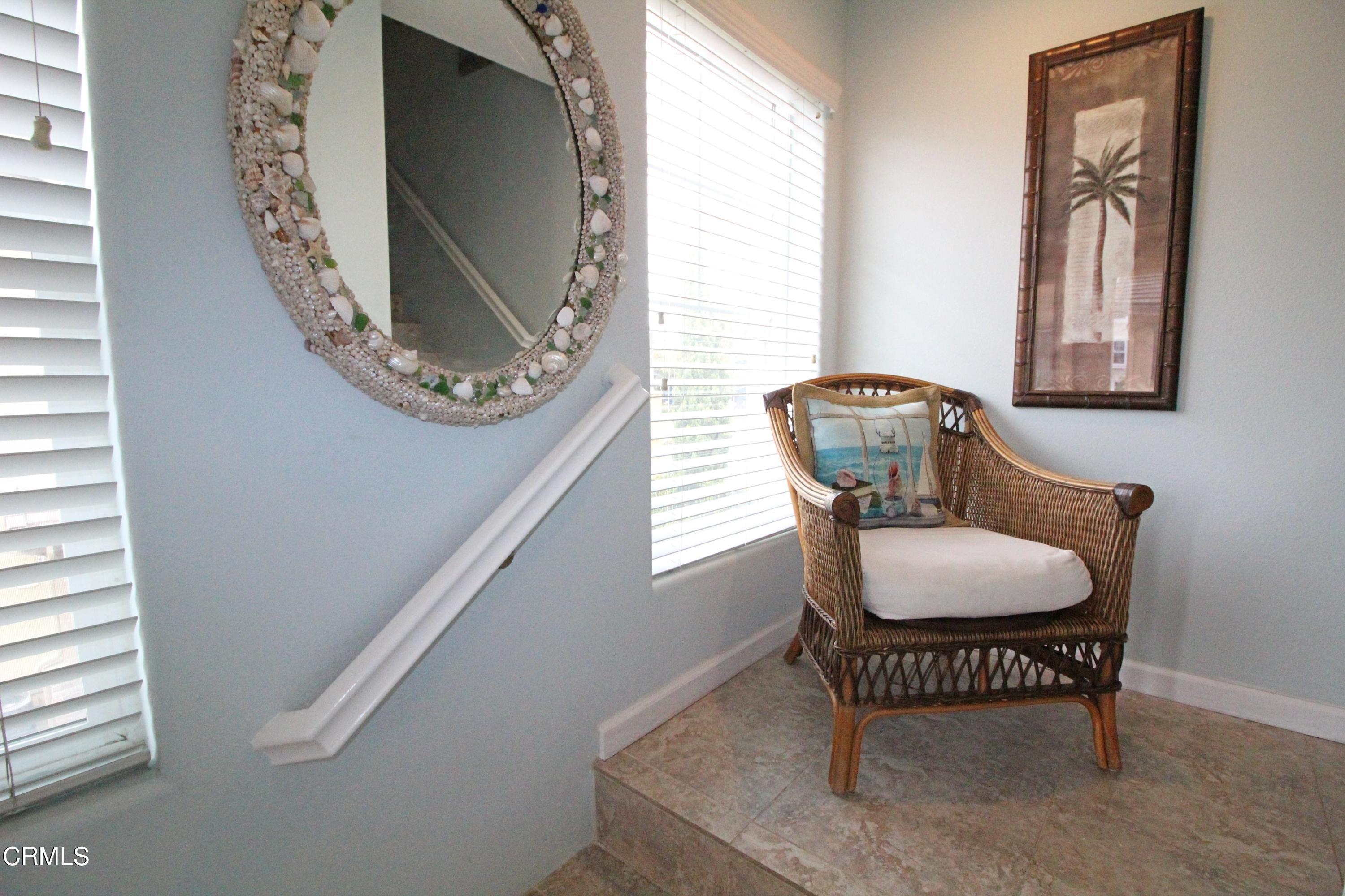 1428 Windshore Way Oxnard, CA 93035 - Photo 10 of 29 a view of a hallway with chairs and a mirror