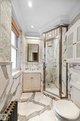 a bathroom with a sink toilet and shower