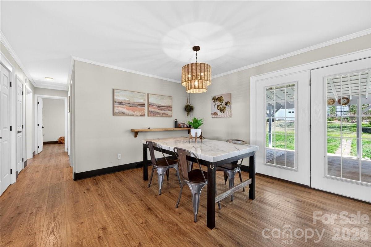 4624 South Olivers Cross Road Maiden, NC 28650 - Photo 11 of 48 a view of a dining room with furniture window and wooden floor
