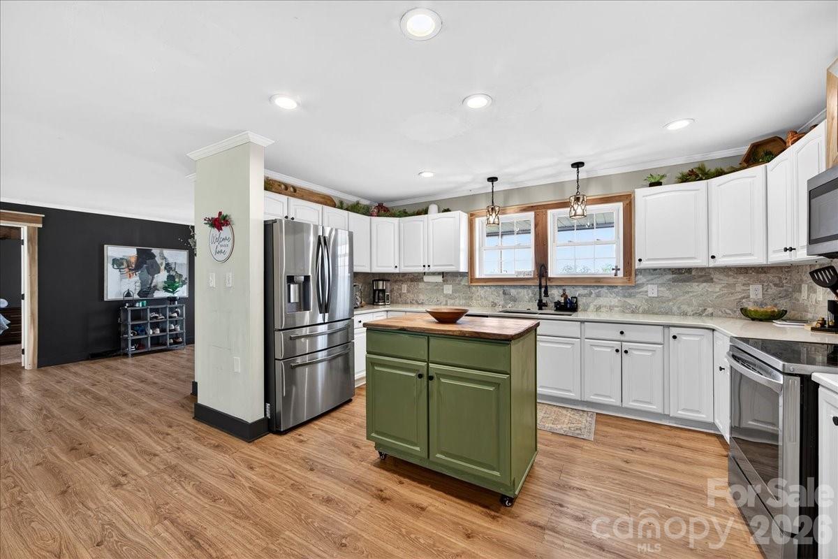 4624 South Olivers Cross Road Maiden, NC 28650 - Photo 13 of 48 a kitchen with a refrigerator cabinets and wooden floor