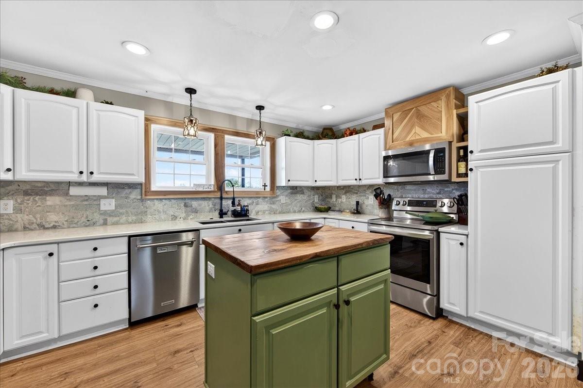 4624 South Olivers Cross Road Maiden, NC 28650 - Photo 15 of 48 a kitchen with a sink cabinets stainless steel appliances and a window