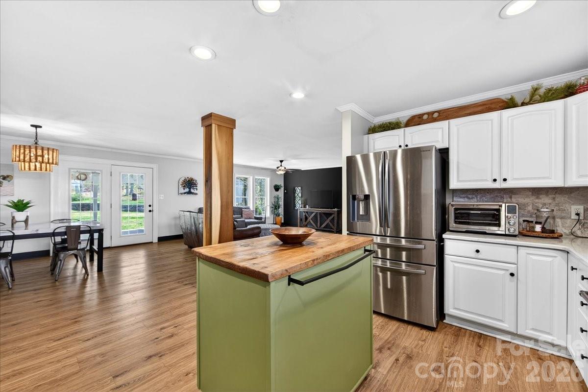 4624 South Olivers Cross Road Maiden, NC 28650 - Photo 17 of 48 a kitchen with stainless steel appliances a stove a sink a refrigerator white cabinets and wooden floor