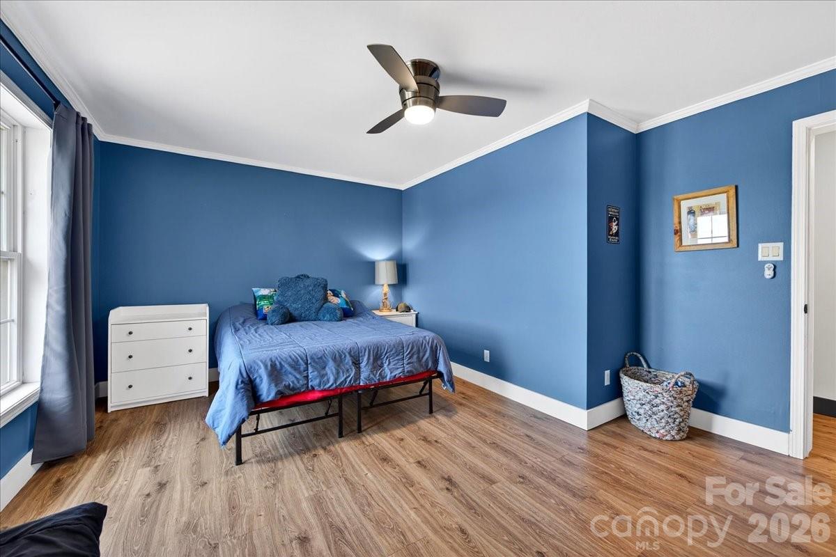 4624 South Olivers Cross Road Maiden, NC 28650 - Photo 26 of 48 a spacious bedroom with a bed and a ceiling fan