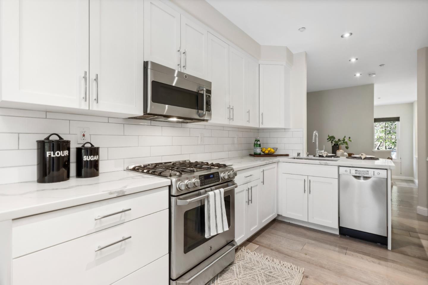 155 Pacchetti Way Mountain View, CA 94040 - Photo 10 of 35 a kitchen with white cabinets and stainless steel appliances