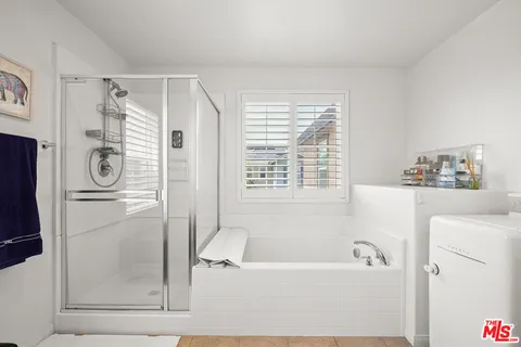 a bathroom with a bathtub and a shower