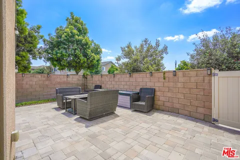 a view of a backyard with outdoor seating