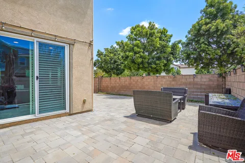 a backyard of a house with outdoor seating