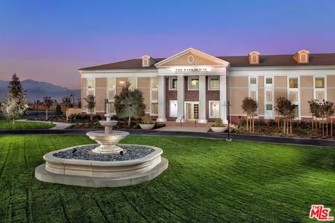 a view of a house with swimming pool and a yard