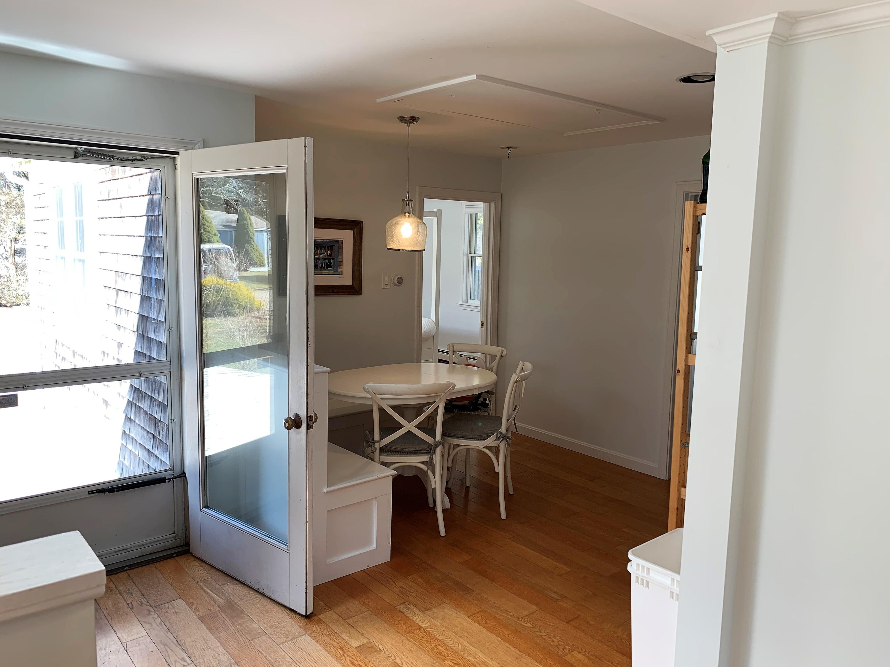 84 Nauset Heights Road Orleans, MA 02653 - Photo 13 of 24 a view of a dining room with furniture and wooden floor
