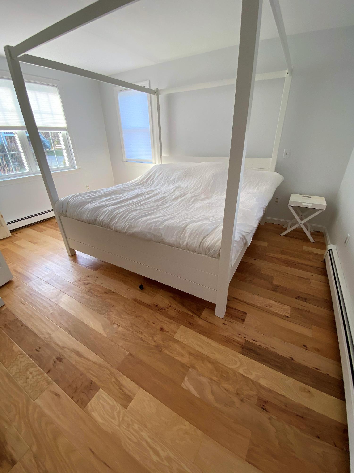 84 Nauset Heights Road Orleans, MA 02653 - Photo 20 of 24 a bedroom with a bed and wooden floor