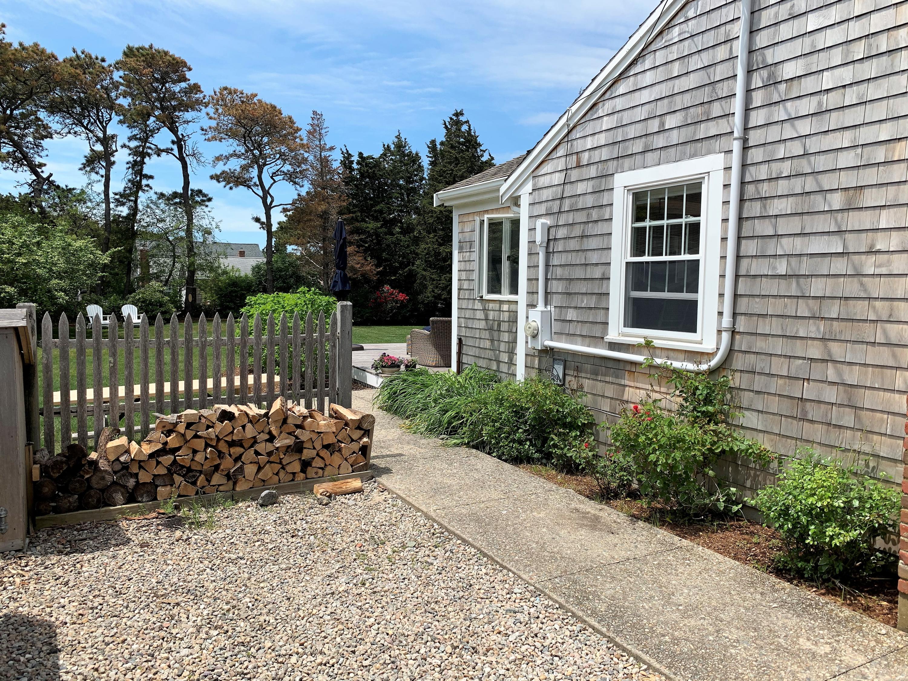 84 Nauset Heights Road Orleans, MA 02653 - Photo 2 of 24 a view of a chair and table in the backyard