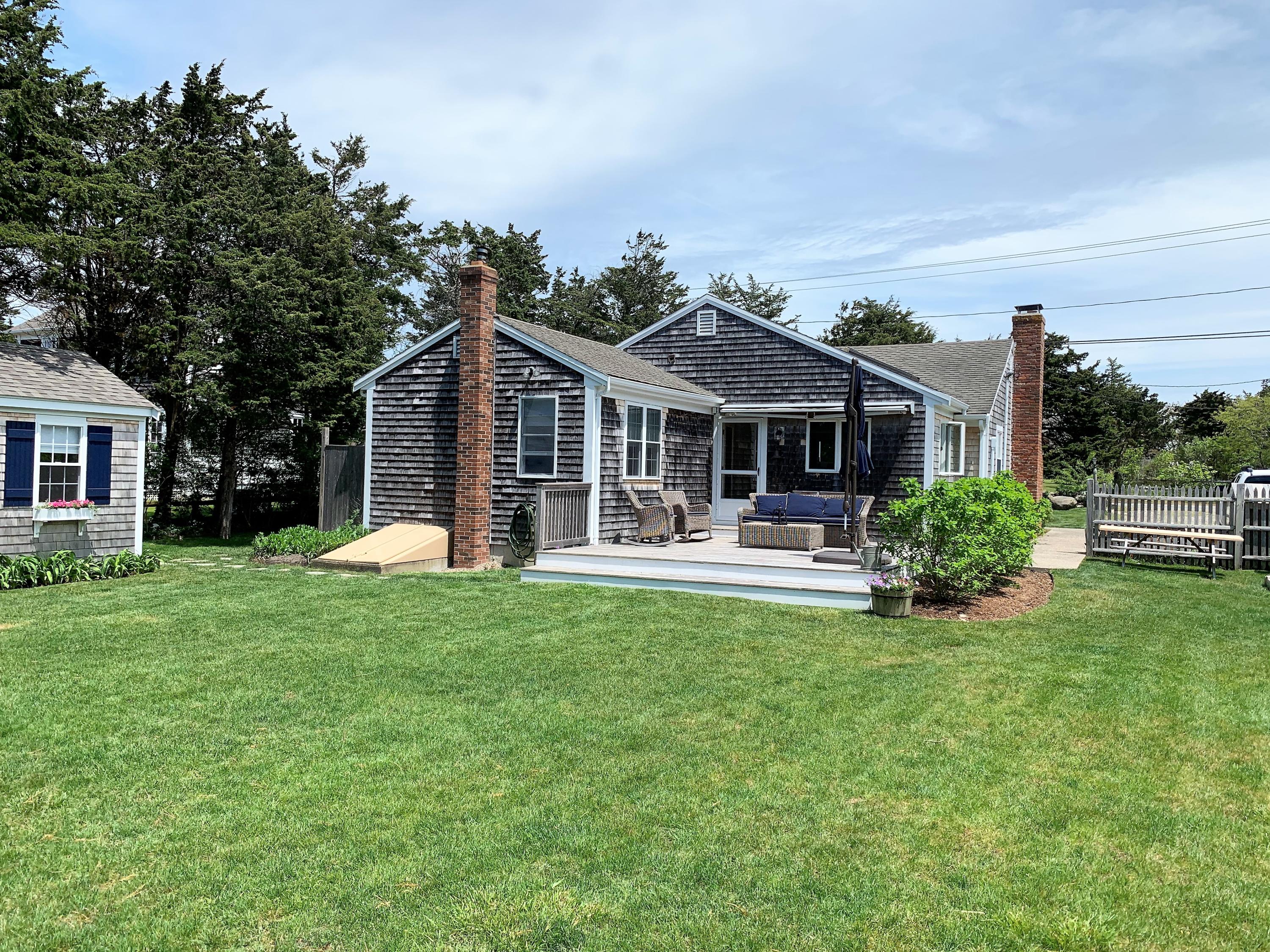 84 Nauset Heights Road Orleans, MA 02653 - Photo 4 of 24 a front view of a house with swimming pool and green space