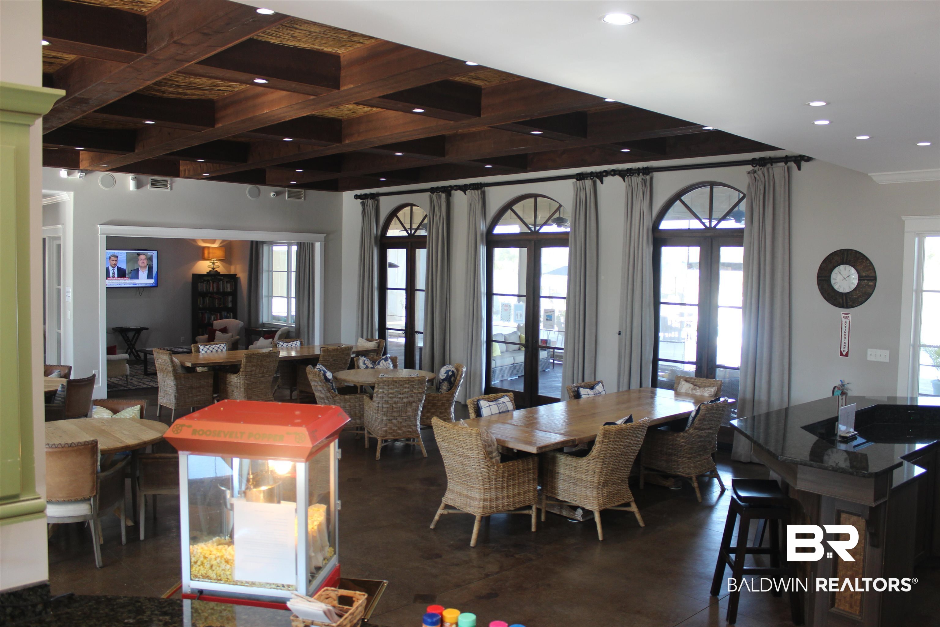 28121 Migratory Way Elberta, AL 36530 - Photo 29 of 51 Dining room featuring coffered ceiling, beamed ceiling, and a wealth of natural light