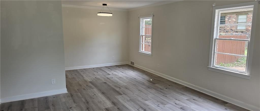628 Farrar Court Avondale Estates, GA 30002 - Photo 7 of 17 an empty room with wooden floor and windows