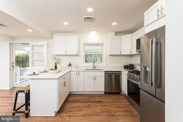 a kitchen with a sink a window and stainless steel appliances