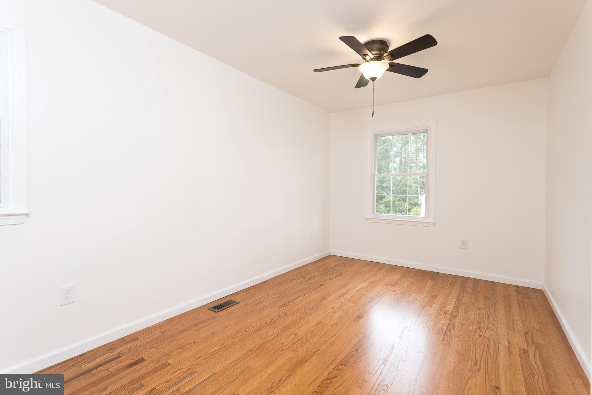 16742 Ridge Road Upperco, MD 21155 - Photo 16 of 38 an empty room with wooden floor and windows