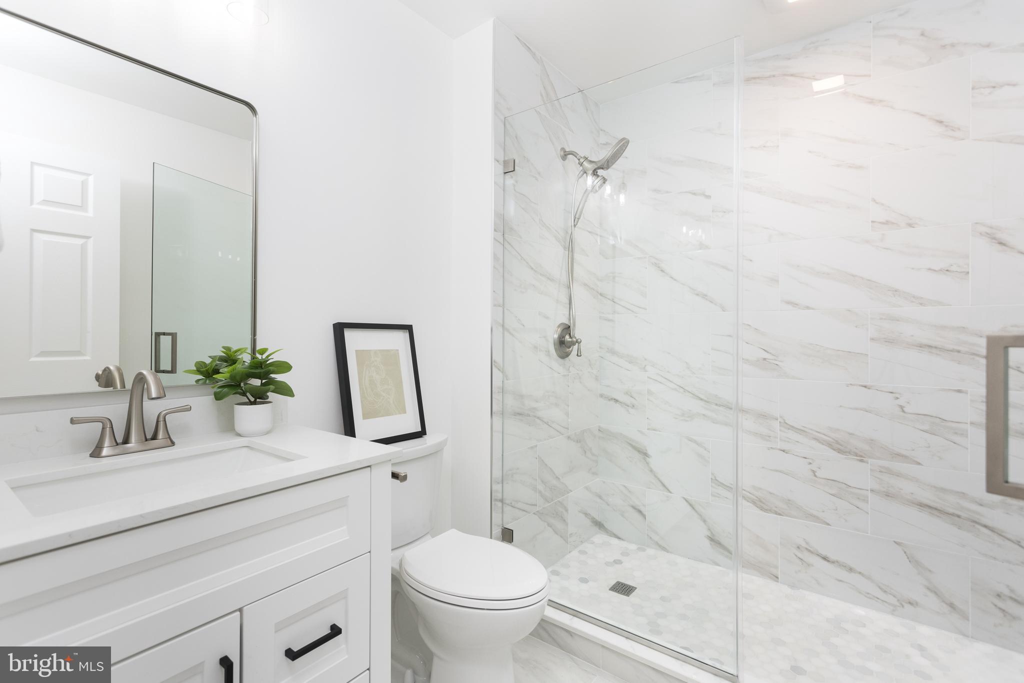 16742 Ridge Road Upperco, MD 21155 - Photo 18 of 38 a bathroom with a granite countertop sink a toilet and shower