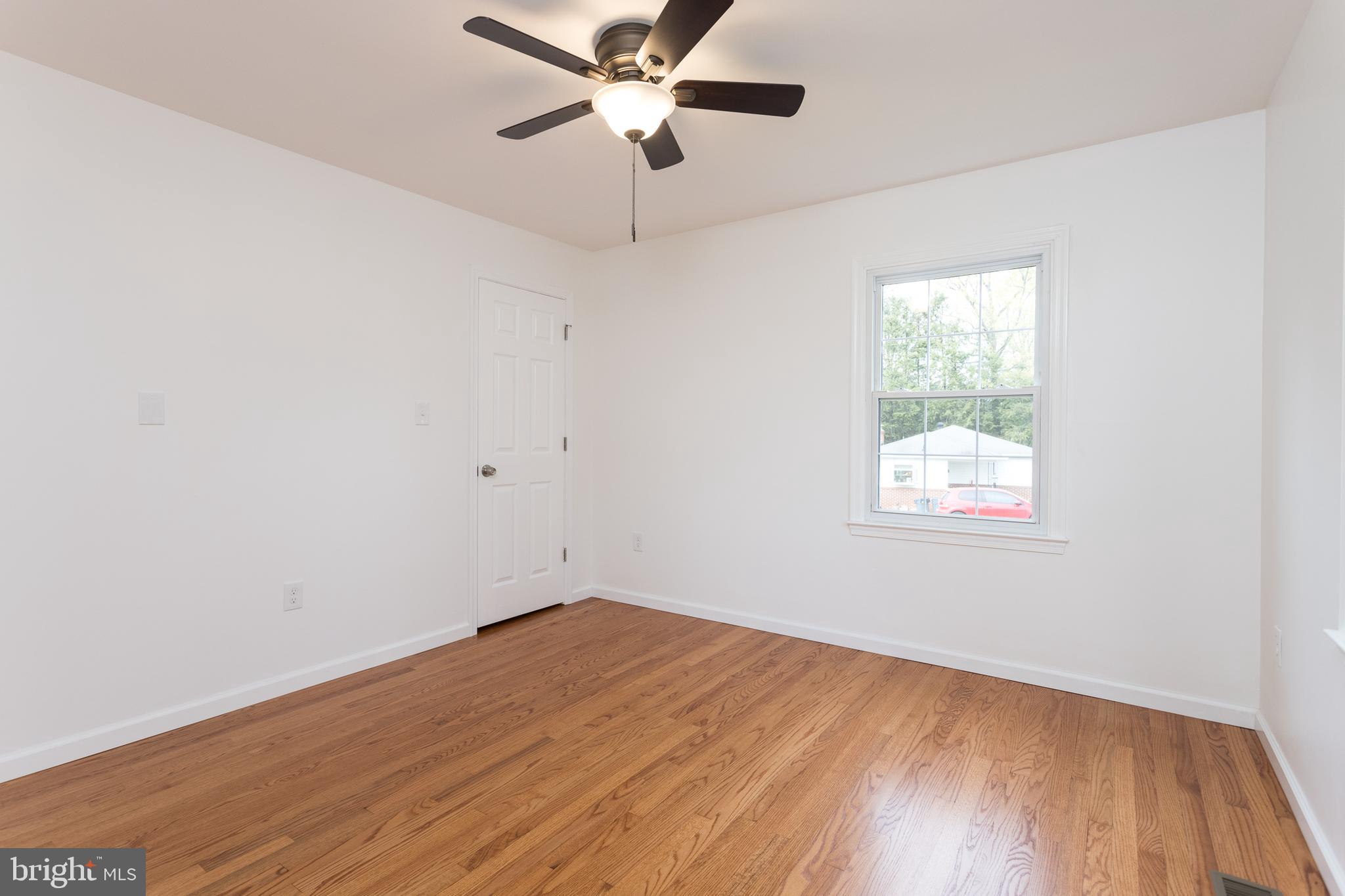 16742 Ridge Road Upperco, MD 21155 - Photo 20 of 38 an empty room with a window and a fan
