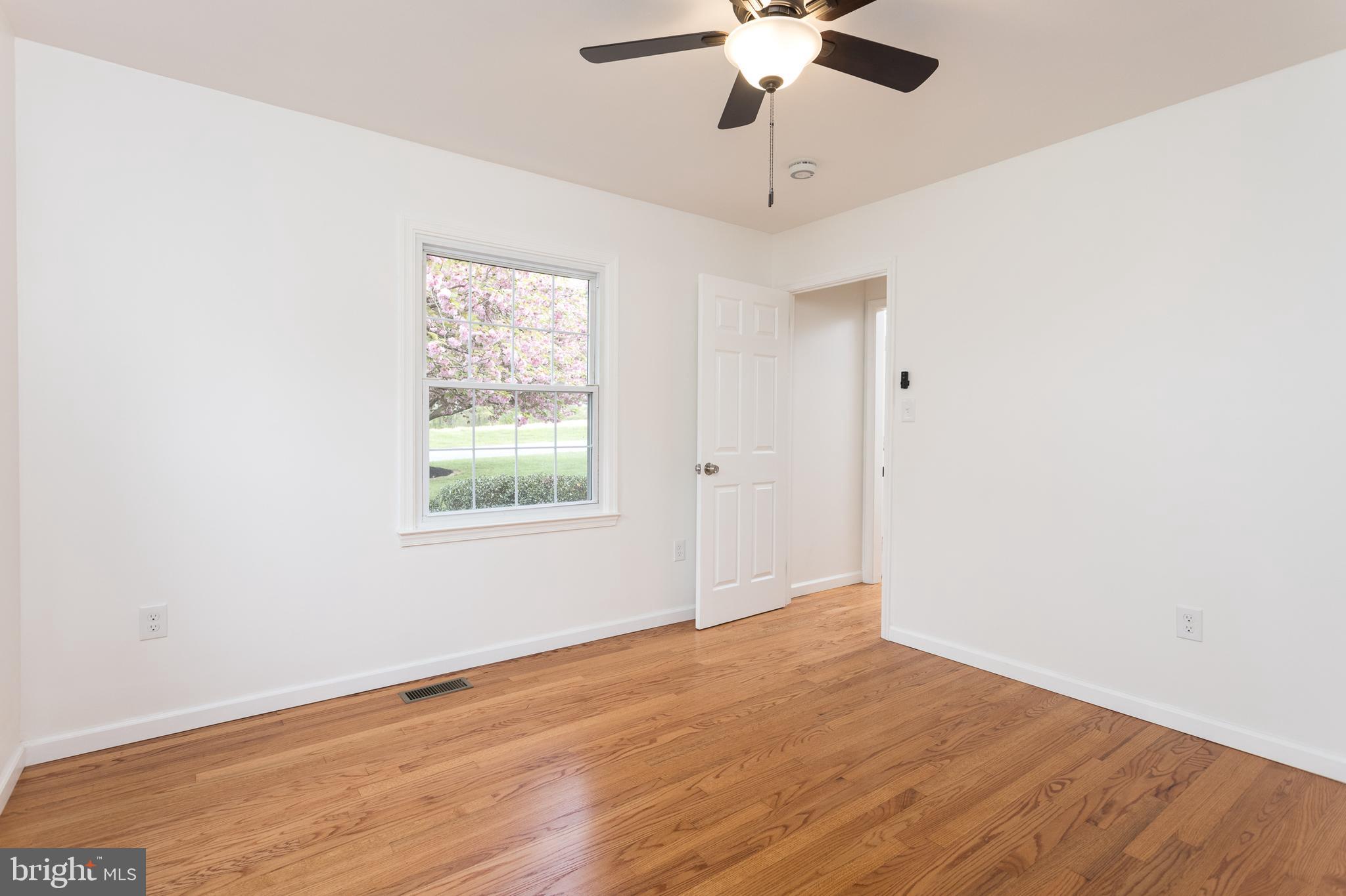 16742 Ridge Road Upperco, MD 21155 - Photo 21 of 38 an empty room with a window and a ceiling fan