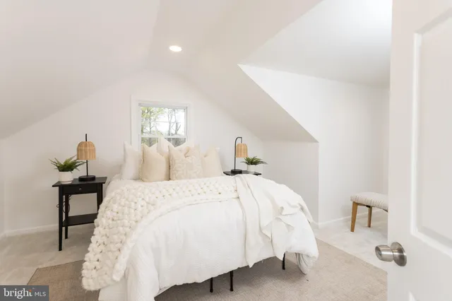 a bed room with a bed and a lamp