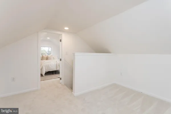 a view of a room and a bathroom with a sink
