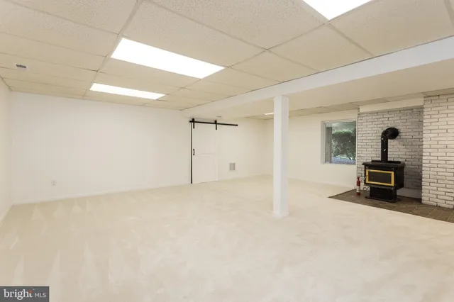 a view of a livingroom with a fireplace and a chandelier