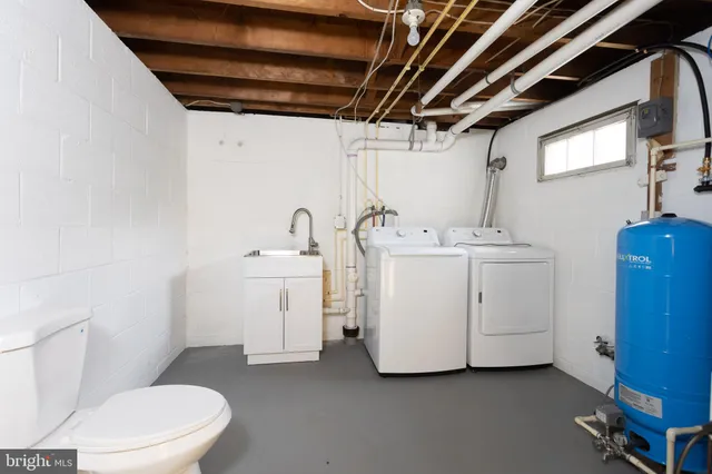 a white toilet sitting next to a bathroom sink