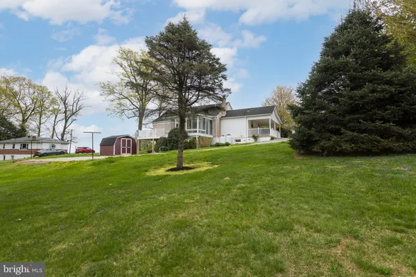 a front view of house with yard and trees