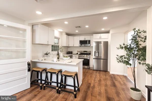a kitchen with refrigerator a microwave and cabinets