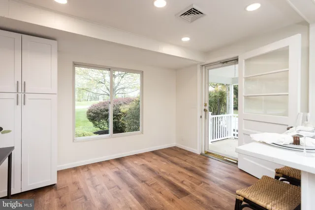 a view of a room with a window and wooden floor
