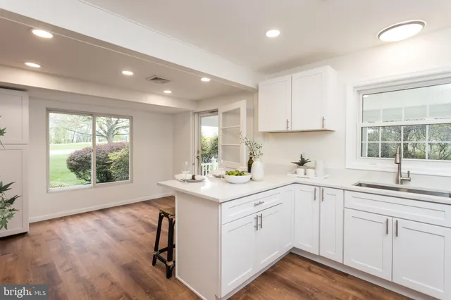 a kitchen with a sink window and cabinets