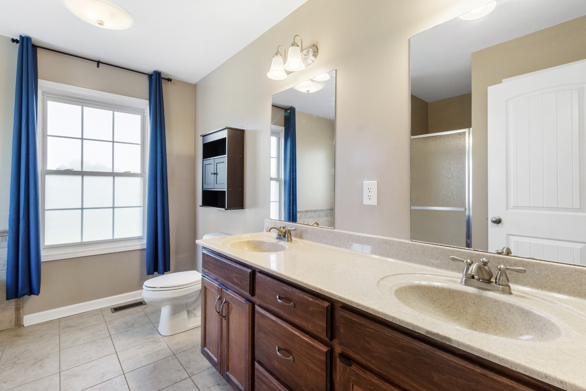3382 Anderson Road Cedar Hill, TN 37032 - Photo 15 of 41 a bathroom with a double vanity sink toilet and a mirror
