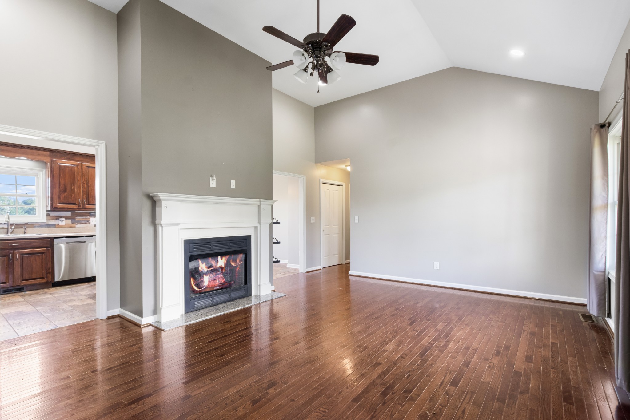 3382 Anderson Road Cedar Hill, TN 37032 - Photo 7 of 41 a view of a livingroom with a fireplace a ceiling fan and fire place