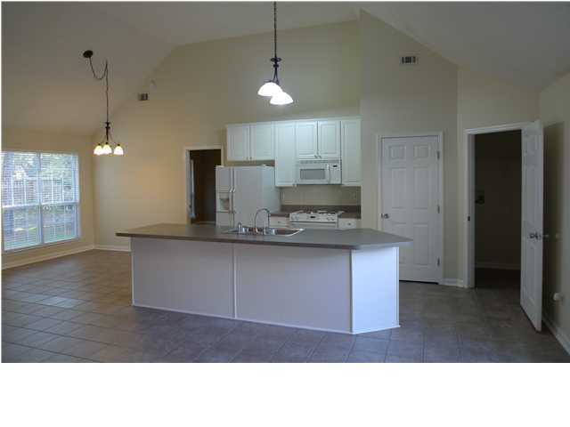 253 Walton Way Miramar Beach, FL 32550 - Photo 11 of 23 a kitchen with kitchen island a counter top space a sink stainless steel appliances and cabinets