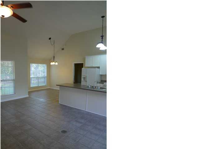253 Walton Way Miramar Beach, FL 32550 - Photo 12 of 23 a view of a kitchen with kitchen island a sink wooden floor and a large window