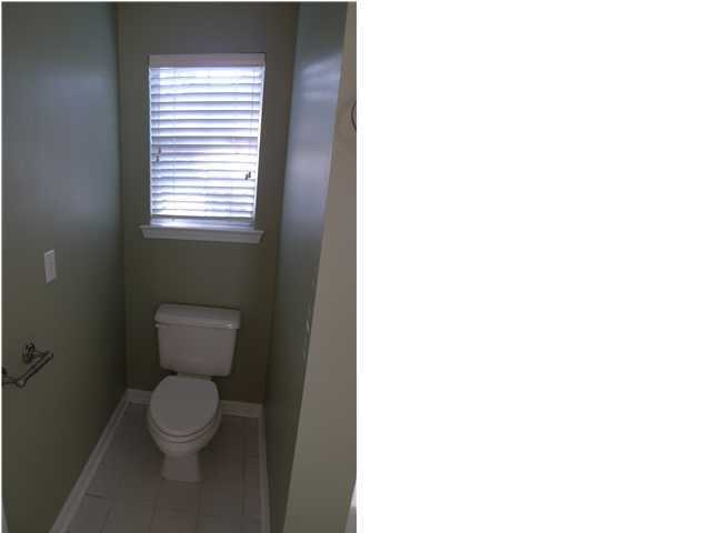 253 Walton Way Miramar Beach, FL 32550 - Photo 19 of 23 a white toilet sitting in a bathroom next to a window