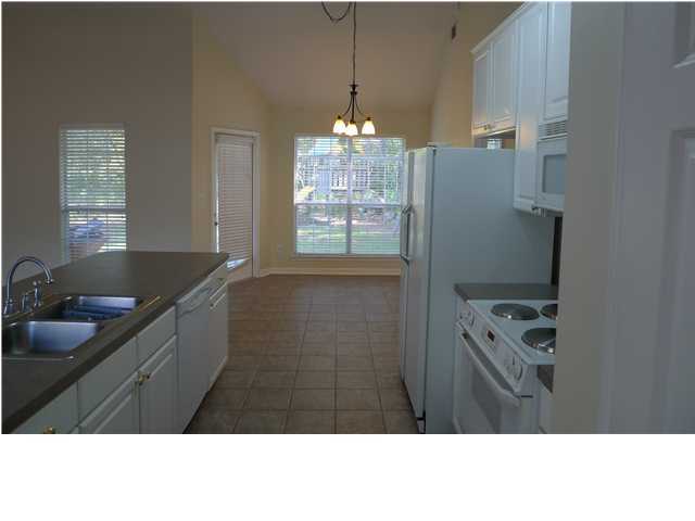 253 Walton Way Miramar Beach, FL 32550 - Photo 21 of 23 a kitchen with granite countertop a sink stainless steel appliances and cabinets