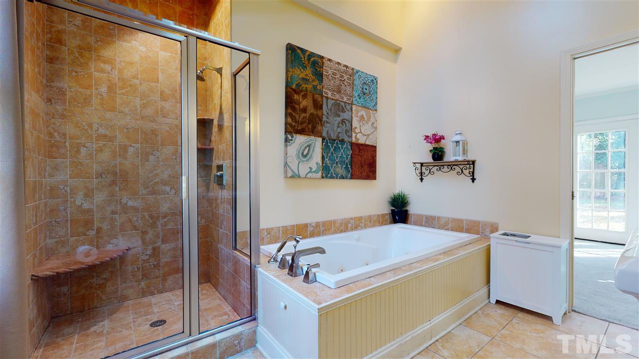 5904 Timber Ridge Drive Raleigh, NC 27609 - Photo 17 of 30 a bathroom with a tub sink shower and mirror