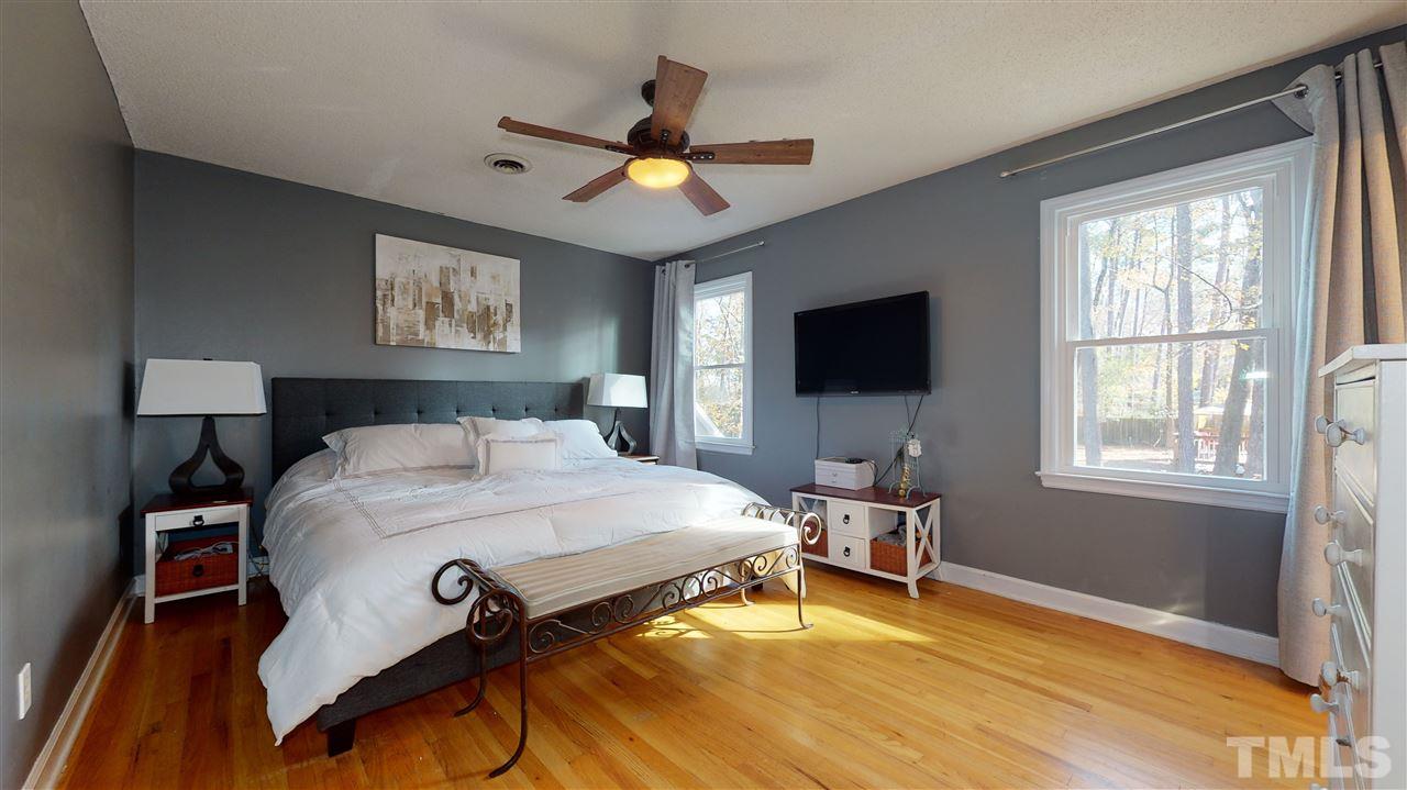 5904 Timber Ridge Drive Raleigh, NC 27609 - Photo 18 of 30 a bedroom with a bed and a flat screen tv