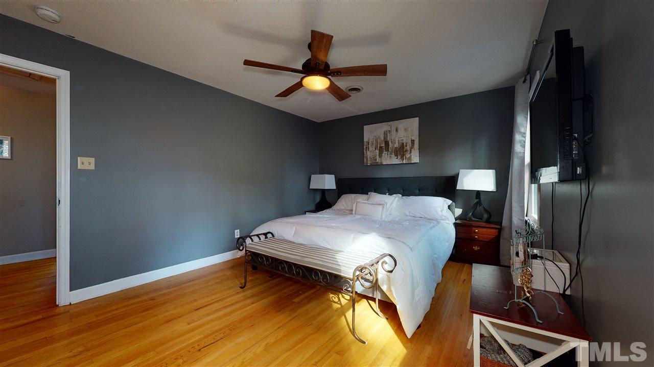 5904 Timber Ridge Drive Raleigh, NC 27609 - Photo 19 of 30 a bedroom with bed and wooden floor