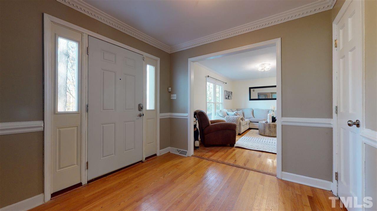 5904 Timber Ridge Drive Raleigh, NC 27609 - Photo 3 of 30 a view of a livingroom with furniture and wooden floor