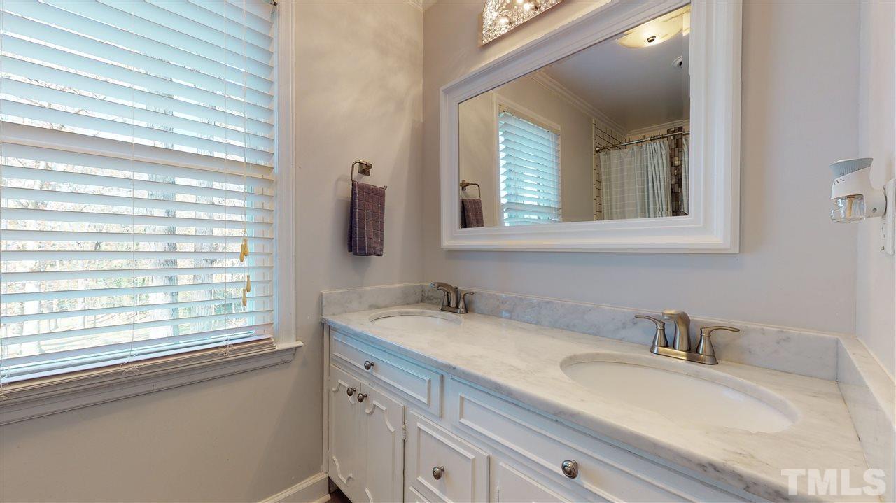 5904 Timber Ridge Drive Raleigh, NC 27609 - Photo 23 of 30 a bathroom with a sink and a window