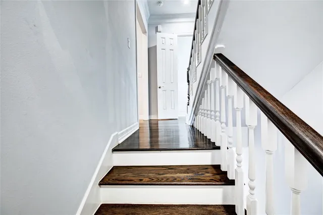 a kitchen with stainless steel appliances a stove a refrigerator a sink dishwasher and a oven with wooden floor