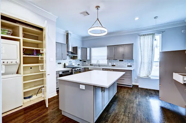 a kitchen with stainless steel appliances a stove and more cabinets