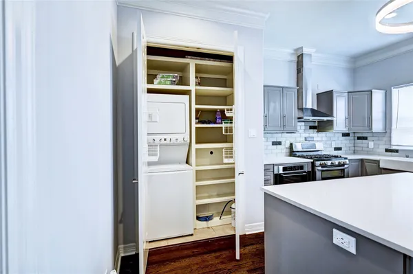 a kitchen with stainless steel appliances granite countertop a sink a stove a refrigerator cabinets and a window