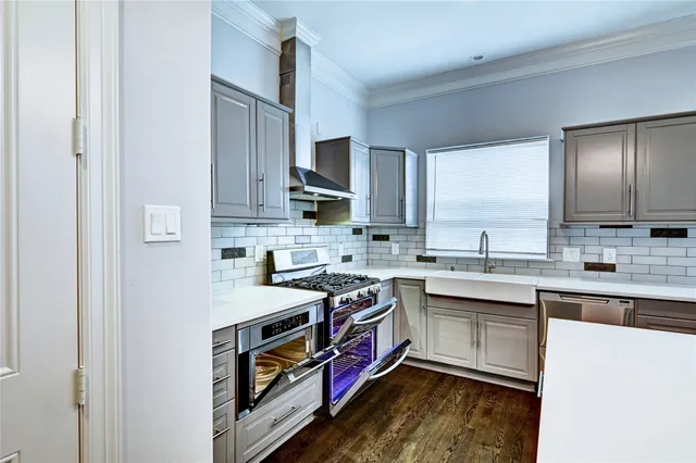 a kitchen with a stove a sink and a refrigerator