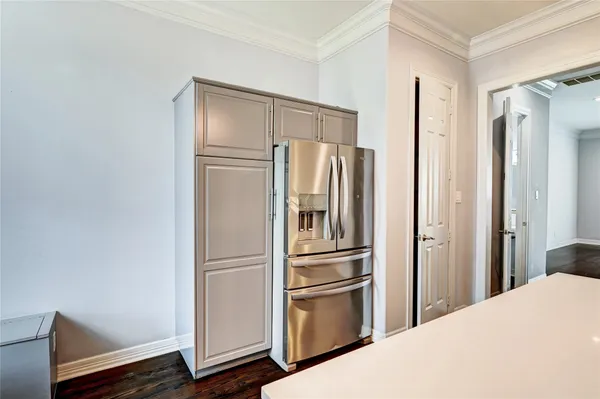 a kitchen with stainless steel appliances a refrigerator and cabinets