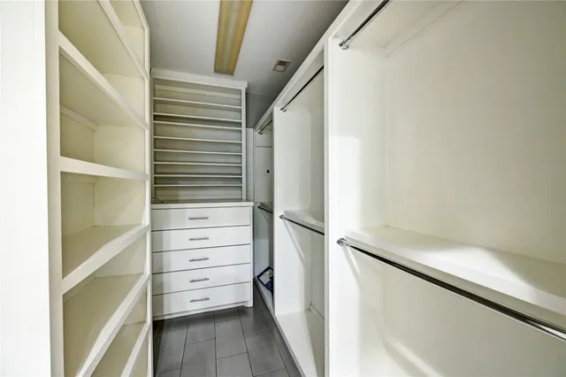 a bathroom with a granite countertop sink a mirror and vanity