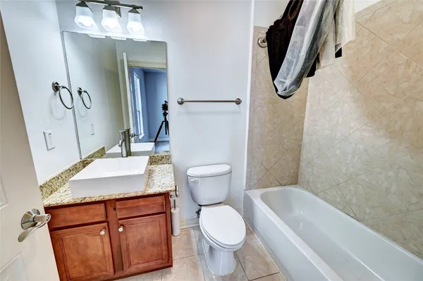 an empty room with closet and a chandelier fan